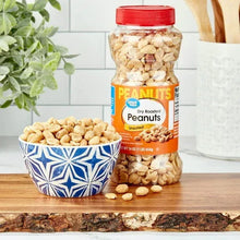 Dry roasted, unsalted peanuts jar beside a bowl filled with peanuts