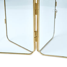 Gold metal folding picture frame side view showing hinges and clear back support
