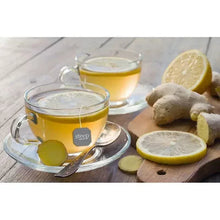 Lemon ginger herbal tea in clear cups with sliced lemon and ginger root