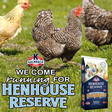 Chickens on grass beside a Henhouse Reserve layer feed bag