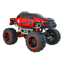 Red RC 4x4 monster truck front 3/4 view with orange shocks and large tread tires
