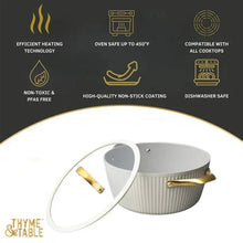White ribbed Dutch oven with gold handles and white lid, front angle