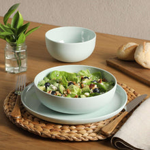 Green melamine bowl and plate with salad