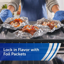 Aluminum foil-lined baking tray with food inside