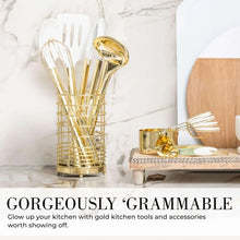 Utensil holder with white silicone spatulas and a gold ladle, gold-toned handles