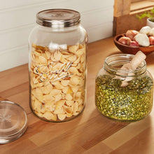 Ball mason jars with stainless lids, clear glass filled with pasta shells and peas
