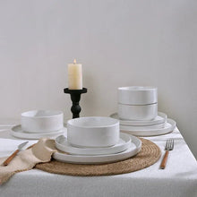 White stoneware dinnerware set: stacked bowls and plates