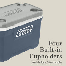 Blue cooler lid and front panel with Coleman badge and built-in cupholders