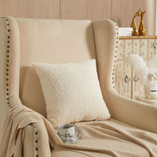 Ivory square boucle decorative pillow on beige upholstered chair