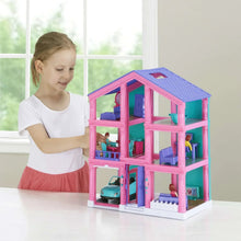 Pink 3-story dollhouse play set on table with child playing beside it