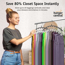 Legging hanger rack with clips holding multiple colorful leggings on a bar