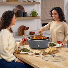 Gray Crock-Pot manual slow cooker with clear lid and side handles, stoneware pot base