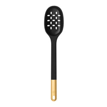 Black silicone skimmer spoon with perforated head and gold handle end