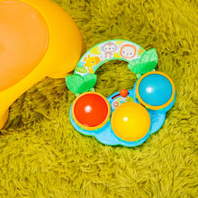 Musical drum toy with green base and three colorful drum pads on a jungle design ring
