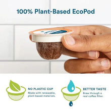EcoPod coffee pod cup held in a hand against a light tiled background