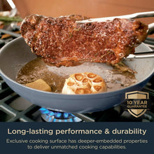 Ceramic non-stick fry pan with blue rim holding seared chicken and sauce