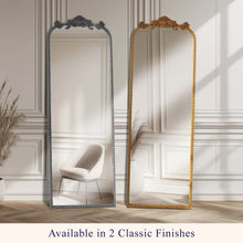 Full-length arch floor mirror with black ornate filigree frame and beaded trim