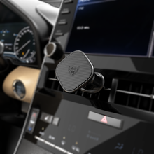 Magnetic phone holder clipped to car air vent, black metal hook mount