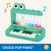 Green crocodile pop piano toy with rainbow character drums and white keys