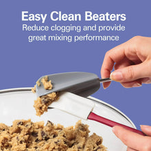 Hand mixer beaters scraping cookie dough from a bowl