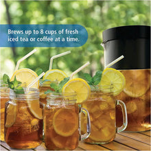 Black iced tea and coffee maker with pitchers of iced tea and coffee and lemon