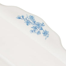 White lid with blue floral vine design