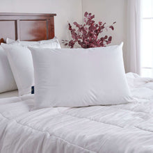 White cooling pillow on a bed with quilted white comforter