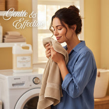 Laundry detergent with towel: woman holding a beige towel by detergent bottles