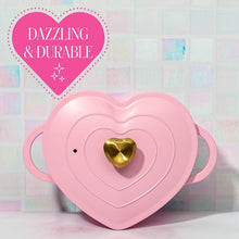 Pink heart-shaped cast aluminum Dutch oven with gold heart knob and side handles