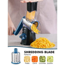 Rotary cheese grater with blue funnel and black base, shredding vegetables into bowl