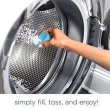 Washing machine drum with a hand dropping blue scent booster beads.