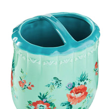 Teal stoneware toothbrush holder with floral side panel and wide mouth