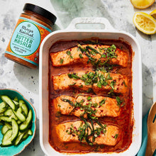 Butter masala simmer sauce jar beside a baked chicken dish in tomato sauce