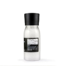 Sea salt grinder with black cap and clear bottle, nutrition label