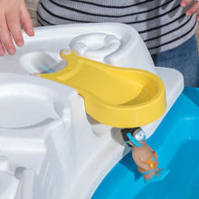 Close-up of yellow water flume and figurines on a blue water table basin