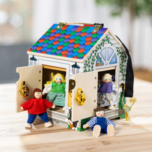 Wooden take-along dollhouse with four poseable dolls standing in front