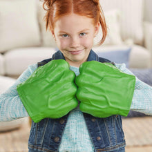 Child holding two green smash fist glove toys, close together at chest