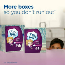 Two purple Ultra Soft facial tissue boxes on a table