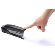 Bostitch one-finger desktop stapler with hand pressing the top handle.