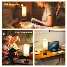 Table lamp pair with warm-lit linen drum shades and black bases