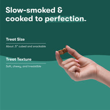 Hand holding a small chicken jerky bites cube treat