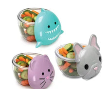 Animal snack containers with clear lids showing carrots and cucumbers; teal shark, gray, purple.