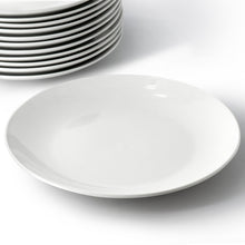 White porcelain round dinner plate, shallow bowl shape, side view.
