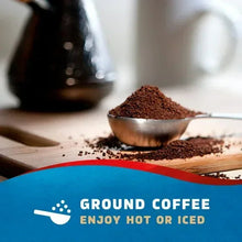Ground coffee grounds with metal scoop and “Ground Coffee” label
