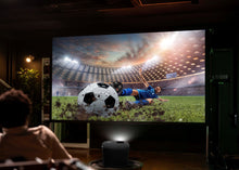 RCA home theater projector on floor, black vented body with front lens