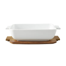 White ceramic oven-to-table serving dish with acacia board