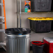 Black trash bag liners in a trash bin with storage tubs and a product box