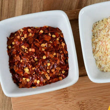 Square bowl of crushed red pepper flakes