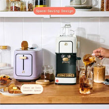 White slim espresso machine with black base and gold knob, compact front view