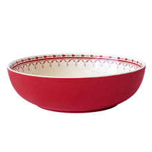 Red stoneware serve bowl with glossy finish and cream rim, front view